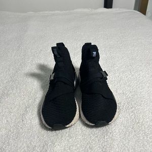 Black and fluorescent women puma shoes.